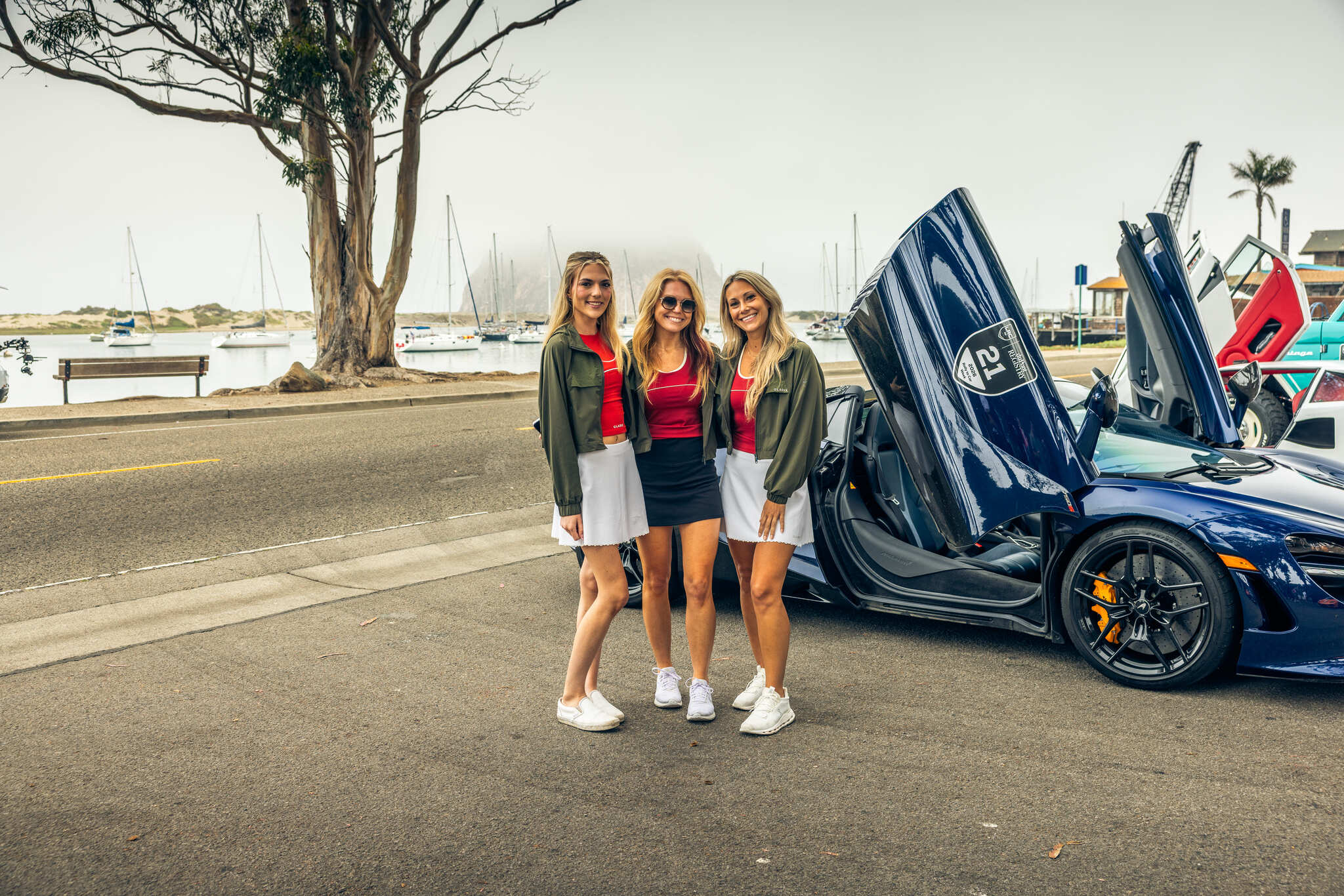 Three of the Luxury Rally Club crew in GLADIX olive jackets at a morning stop in Morro Bay
